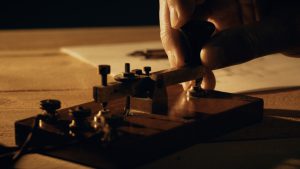 dolly closeup of a telegrapher using a morse code key (0;00;06;09)